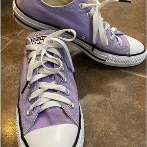 Purple converse shoes.